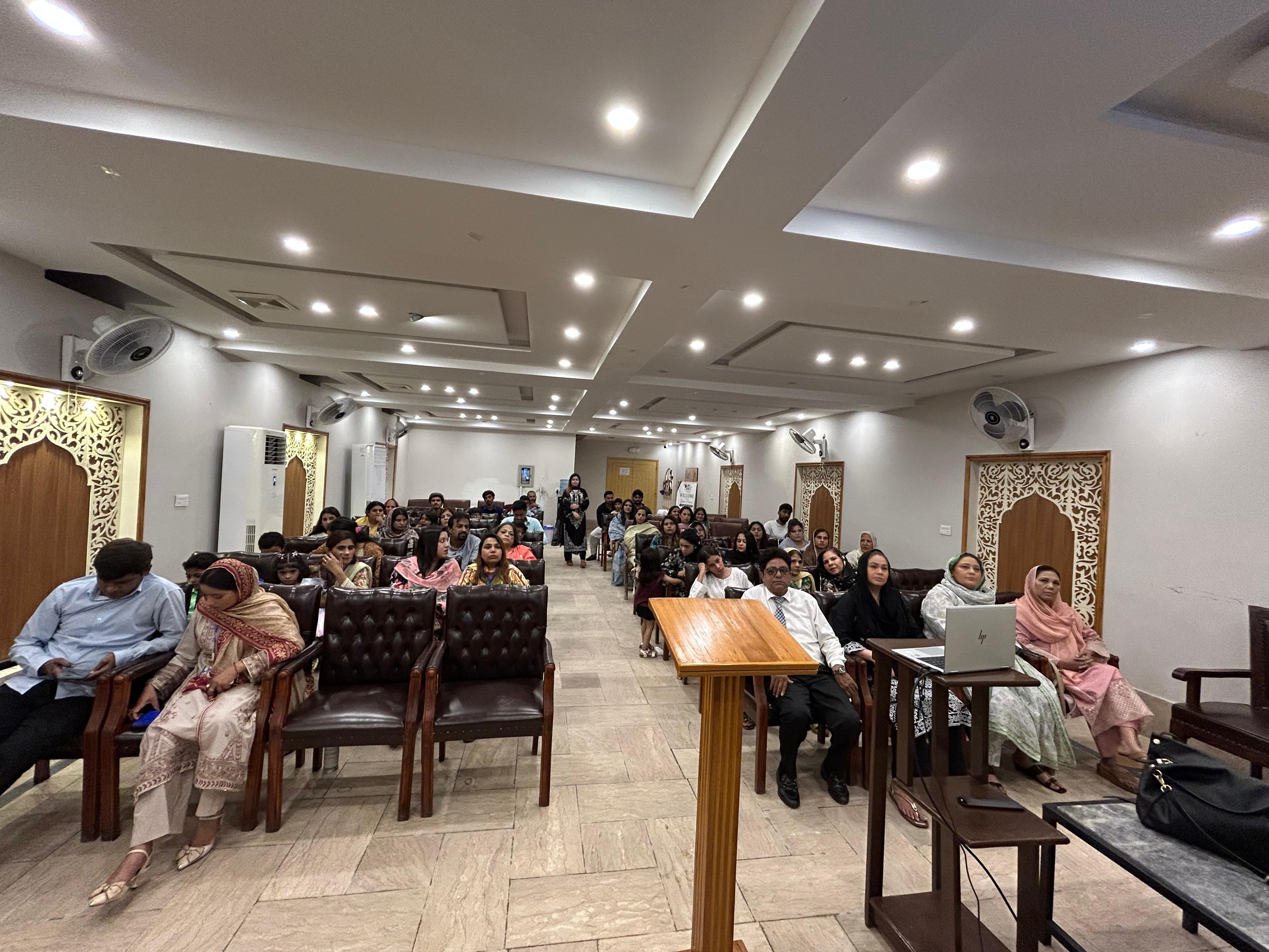 A full room of students seated for Lamp For The Nations orientation in Lahore, Pakistan